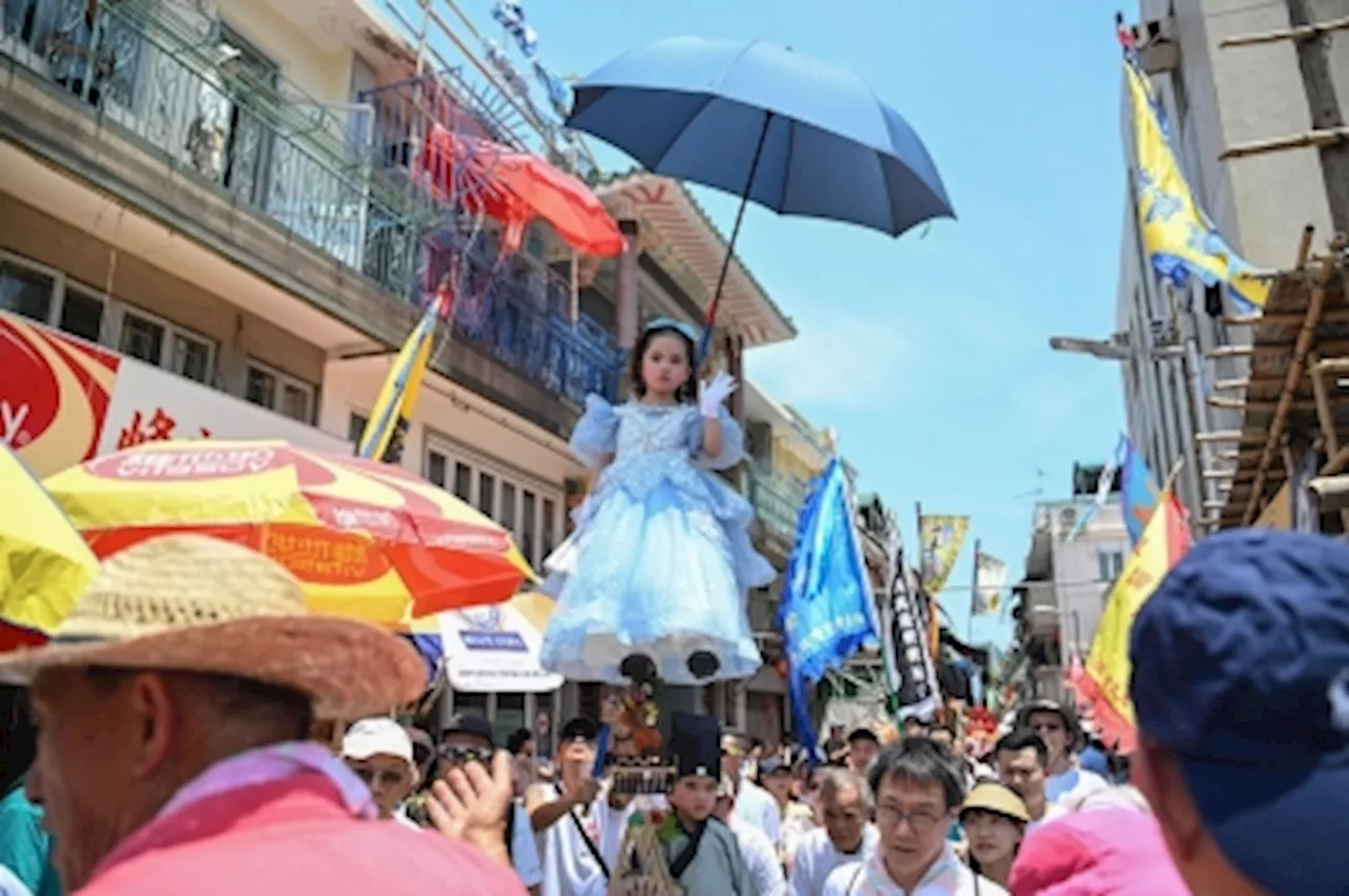 Child mascots and bun towers: Hong Kong keeps island traditions alive