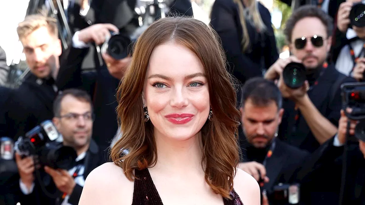 Emma Stone wears extreme plunging gown as she graces the red carpet alongside a stunning Eva...