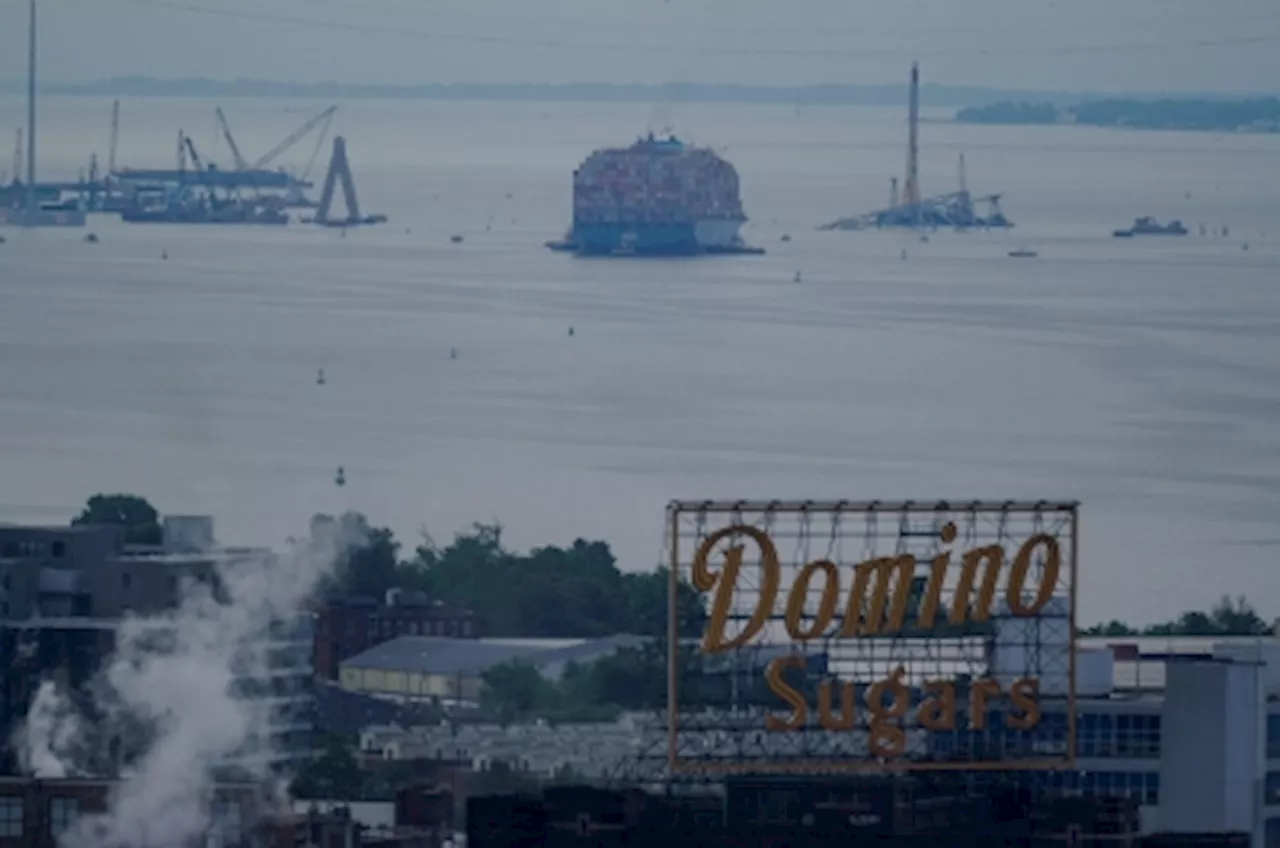 Crashed ship that took down Baltimore bridge refloated, towed from channel