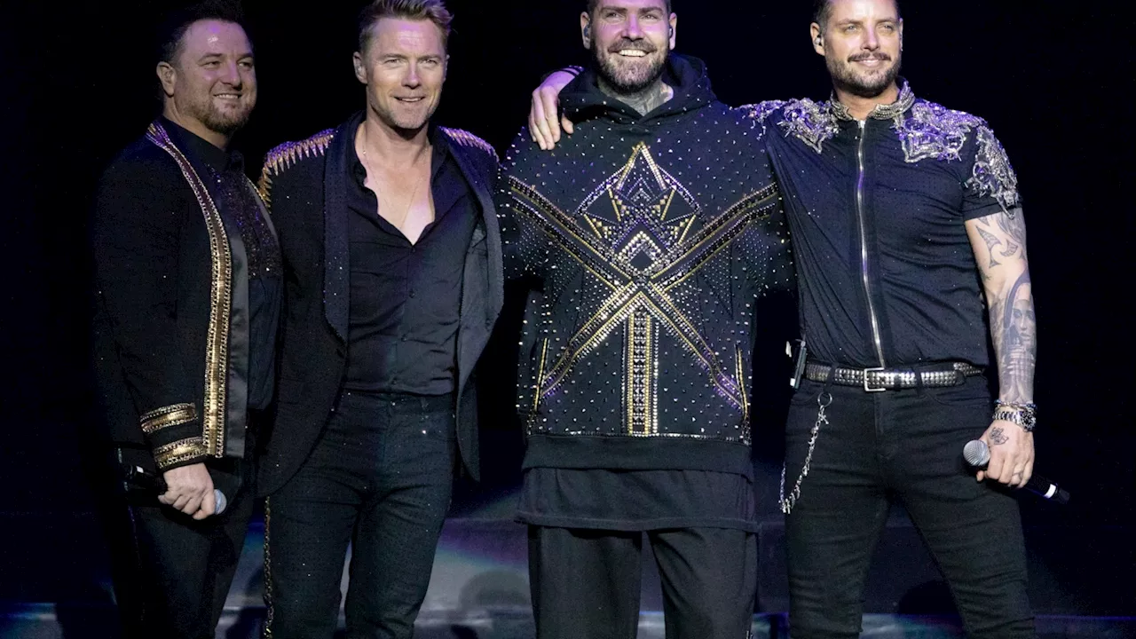 Boyzone star shocks fans as he watches Bruce Springsteen gig with Brad Pitt...