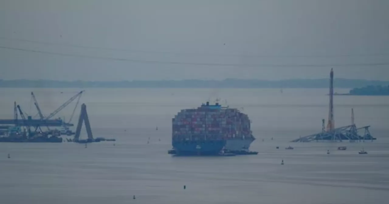 Crashed ship that took down Baltimore bridge refloated, towed from channel