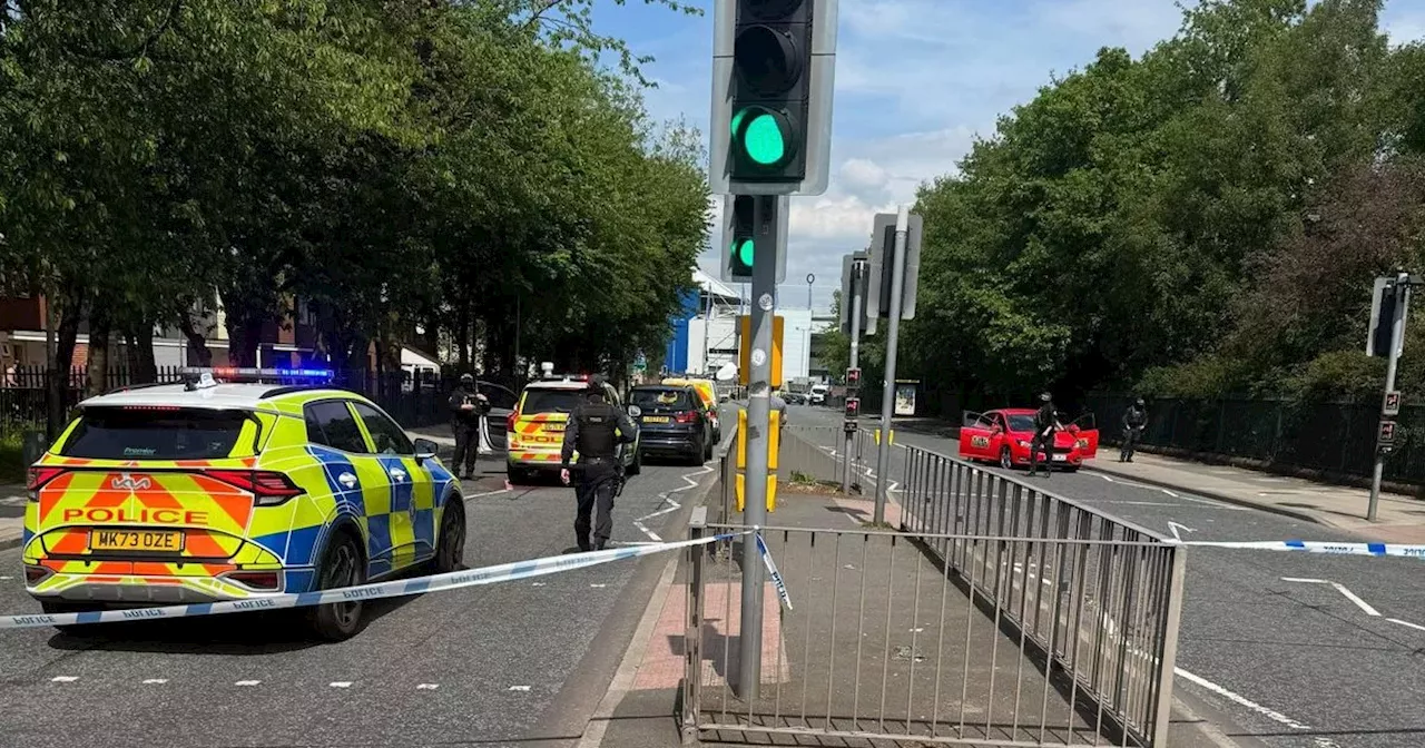 Live updates as armed police cordon off major road