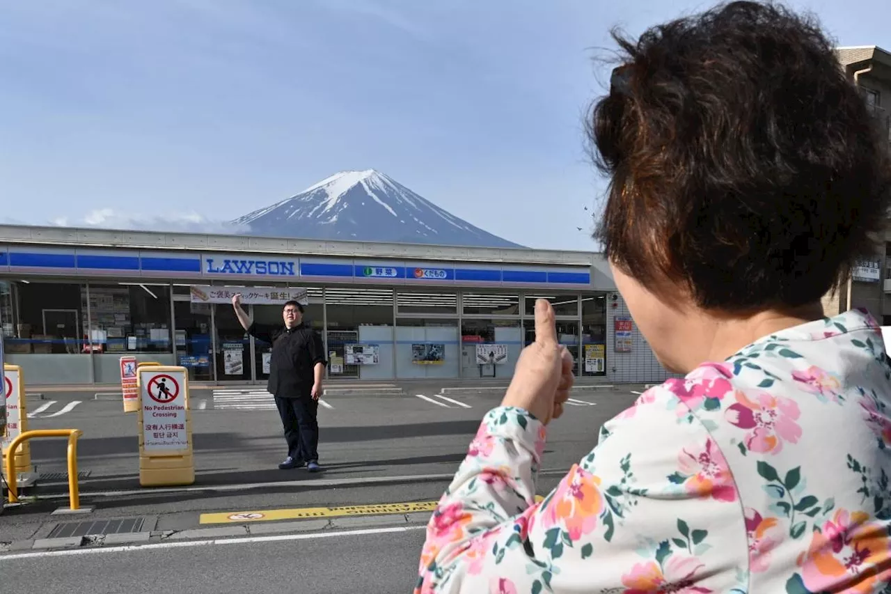 Sick of tourists, Japan town blocks view of Mt Fuji