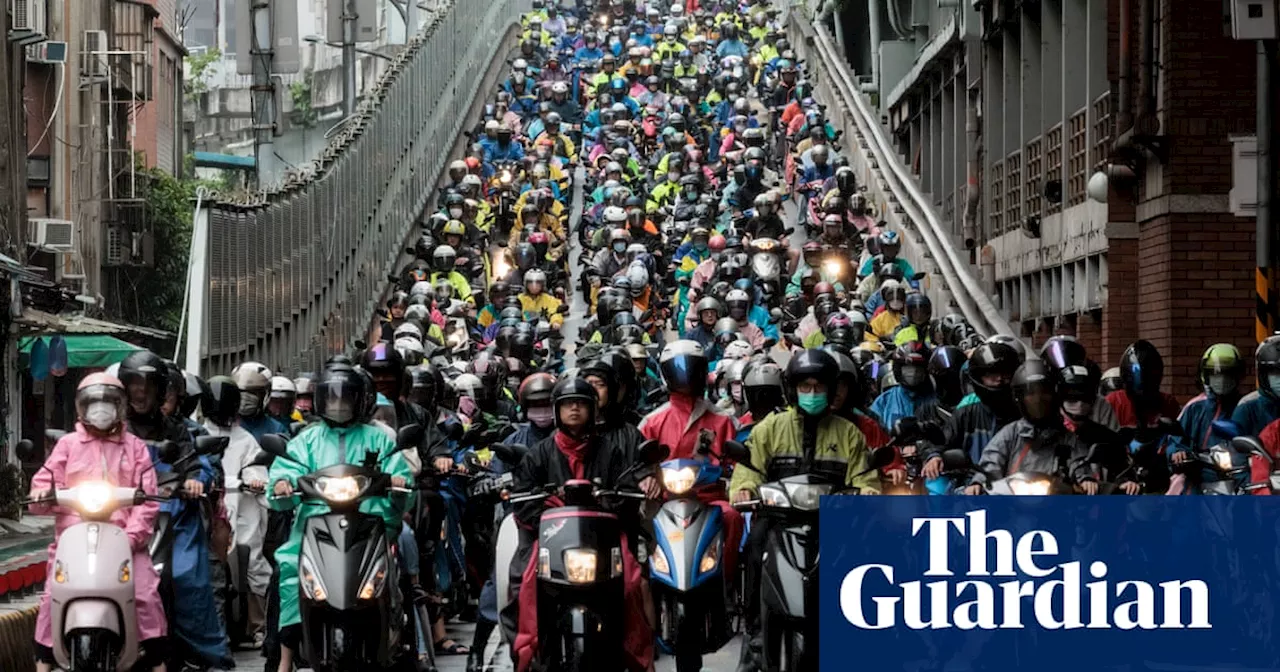 Scooter commuters and a bee nest: photos of the day