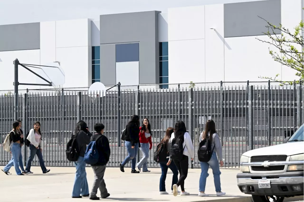 How many Inland Empire schools are next to warehouses?