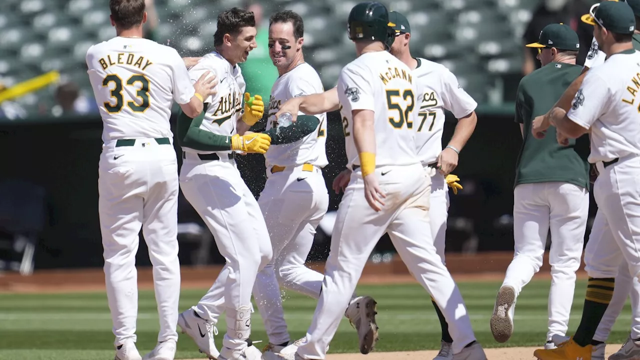 A's hit 2 tying homers in late innings and score 5 in 11th to rally past Rockies