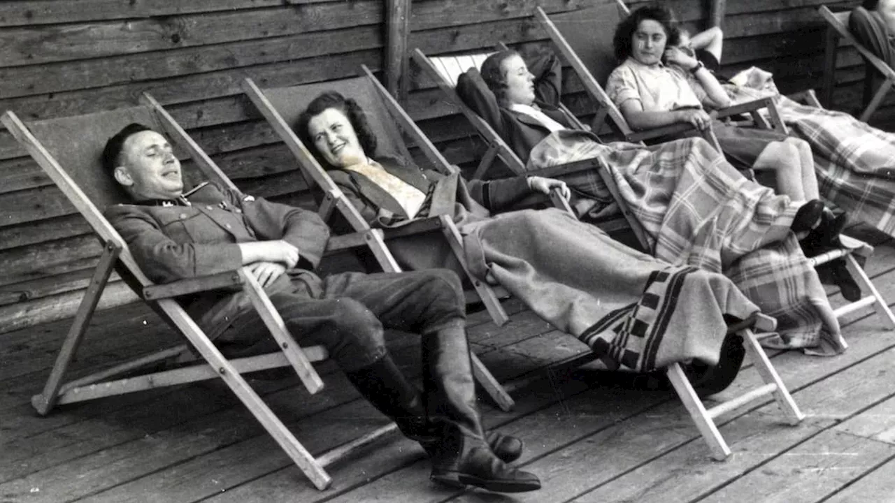 Summer getaway for the monsters of Auschwitz: Chilling images show Nazis sunbathing on deckchairs, a...