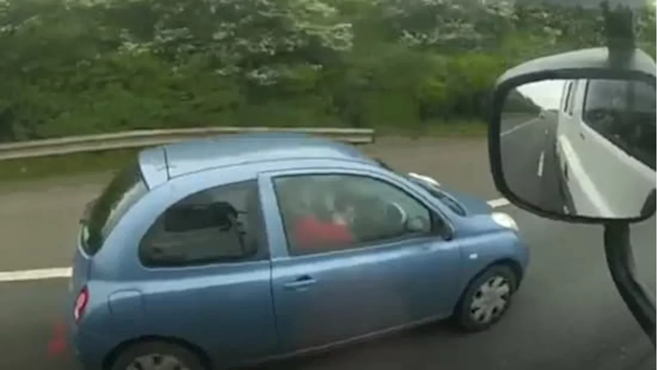 Moment woman applies make-up while driving in morning traffic on the motorway captured in shocking footage