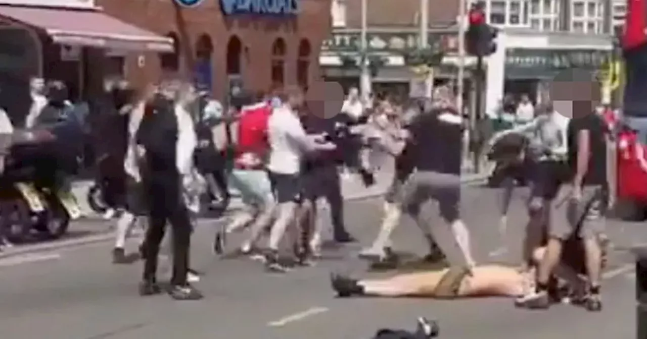 Man 'unconscious' on street as Man Utd and Man City fans clash in violent brawl