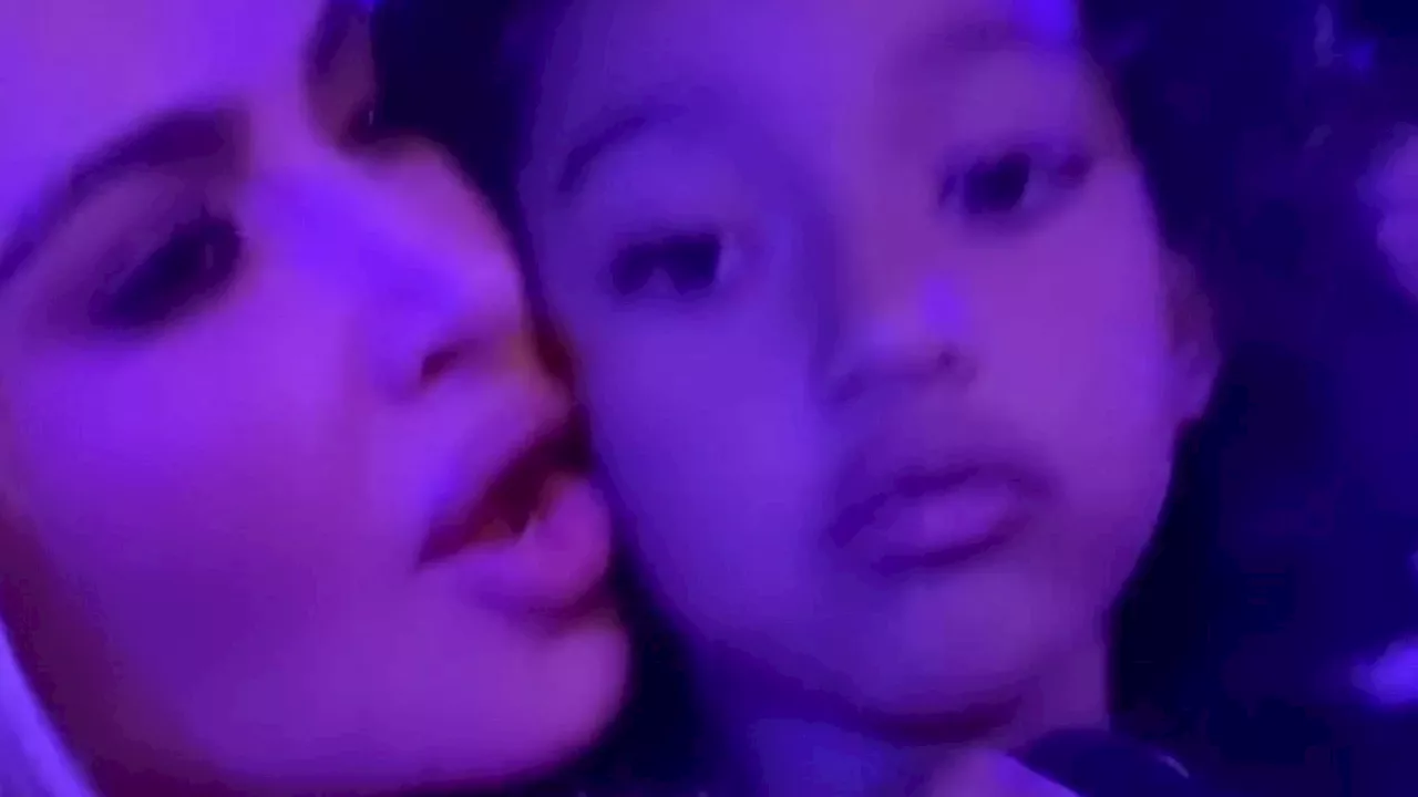 Kim Kardashian lovingly holds daughter Chicago, six, in her lap as she sings along with North, 10,...