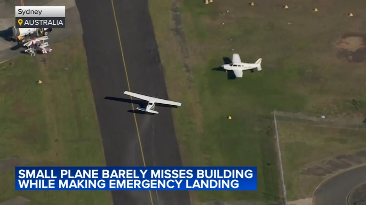 Small plane loses power and skims suburban rooftops before making crash landing on belly