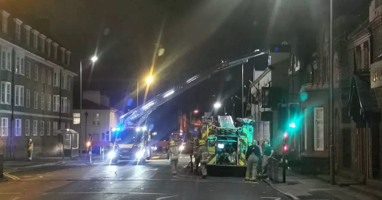 Fire crews called as blaze rips through building's roof