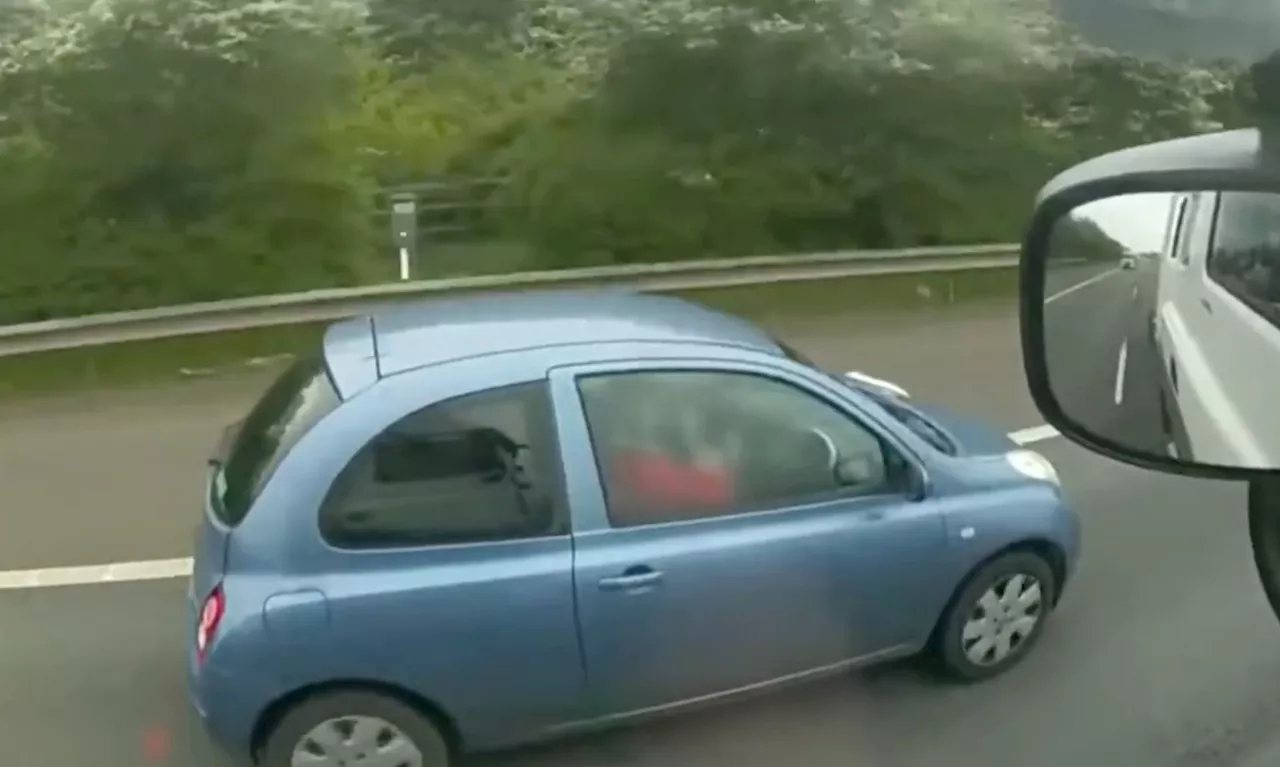 Police capture 'shocking' footage of driver applying make-up as she drives along M40