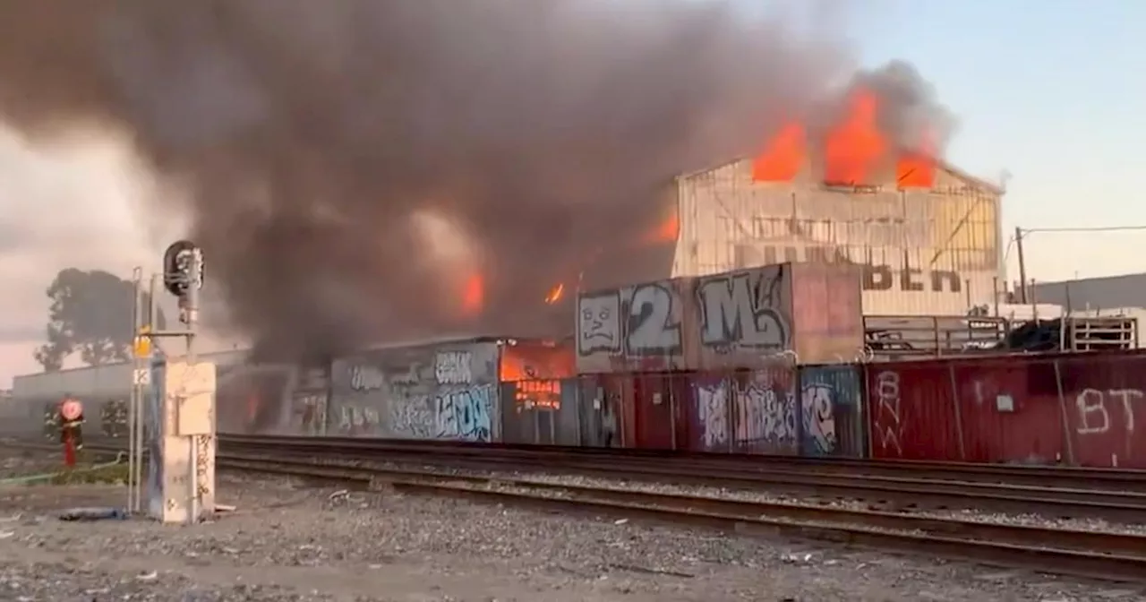 Fire that destroyed warehouse at Oakland lumber yard contained; cause under investigation