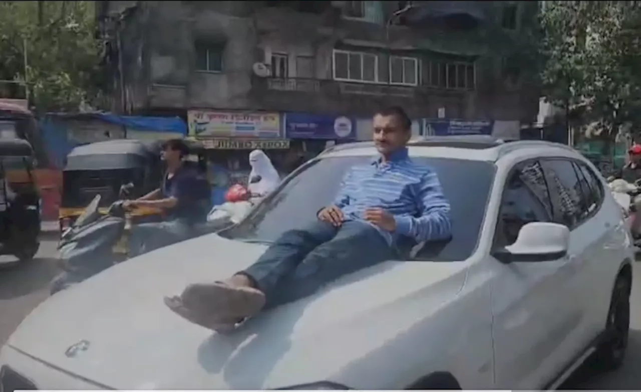 VIDEO: बीच सड़क नाबालिग ने BMW के बोनट पर शख्स को लेटाकर किया स्टंट