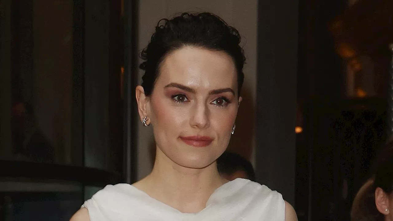 Daisy Ridley wows in an ethereal white gown as she leaves her London hotel ahead of guest appearance...