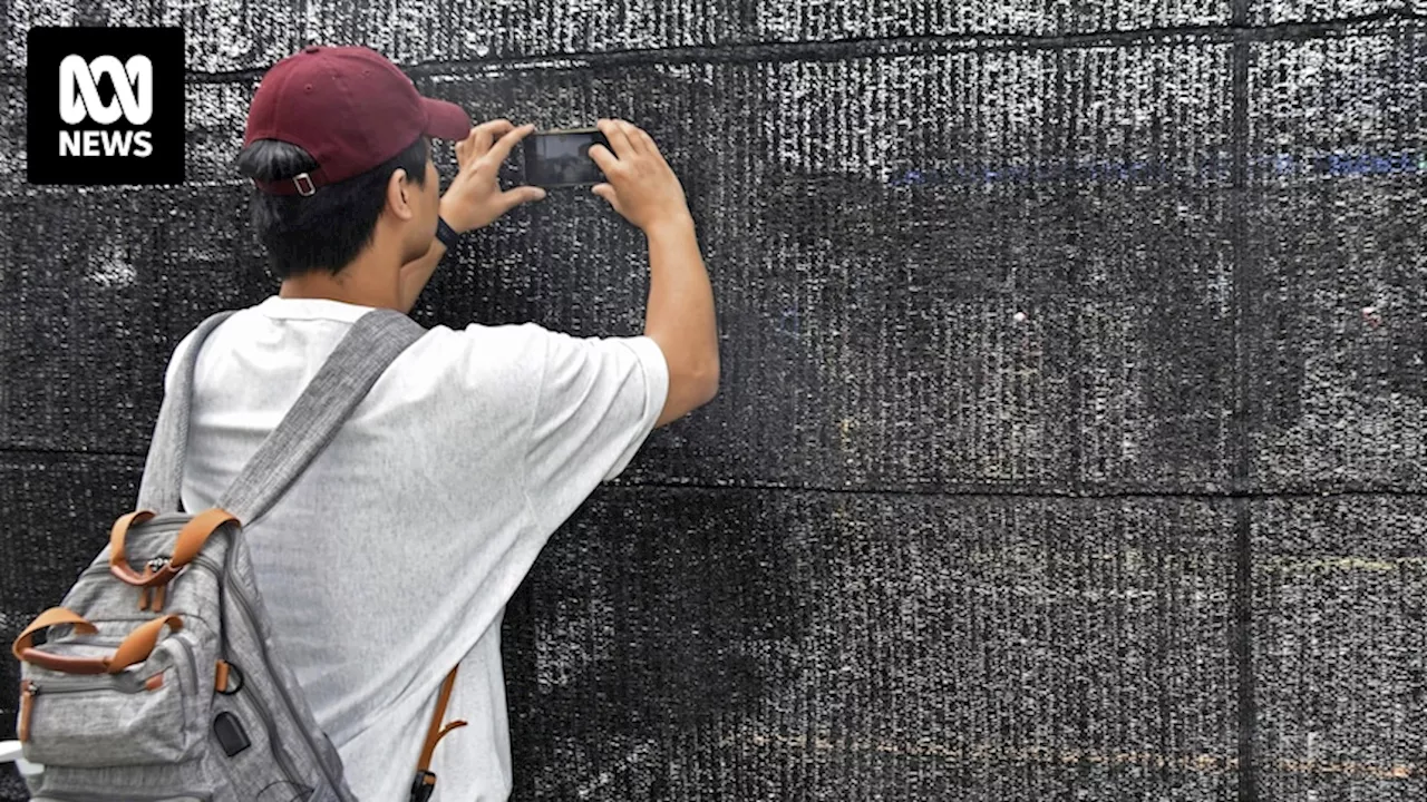 Holes found in Japanese town's screen blocking tourists from taking photos of Mount Fuji