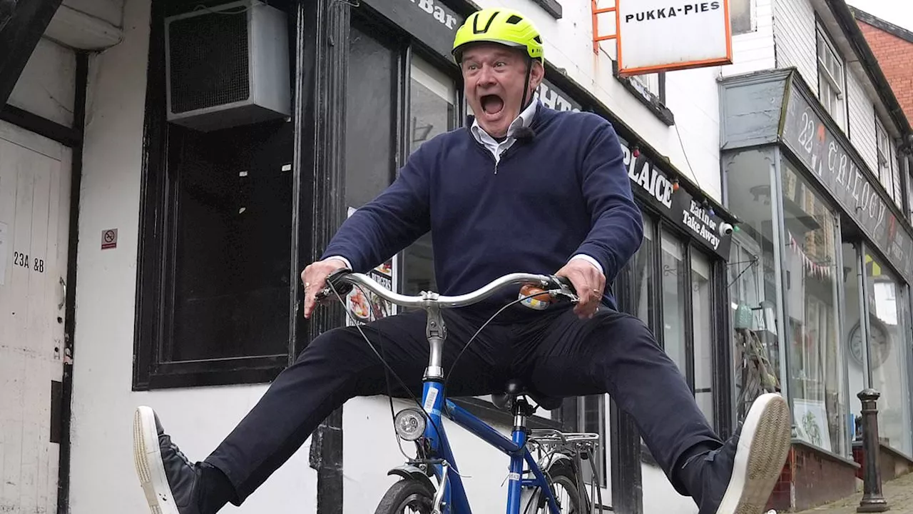 Lib Dem leader Ed Davey clowns around on bike after paddleboard stunt