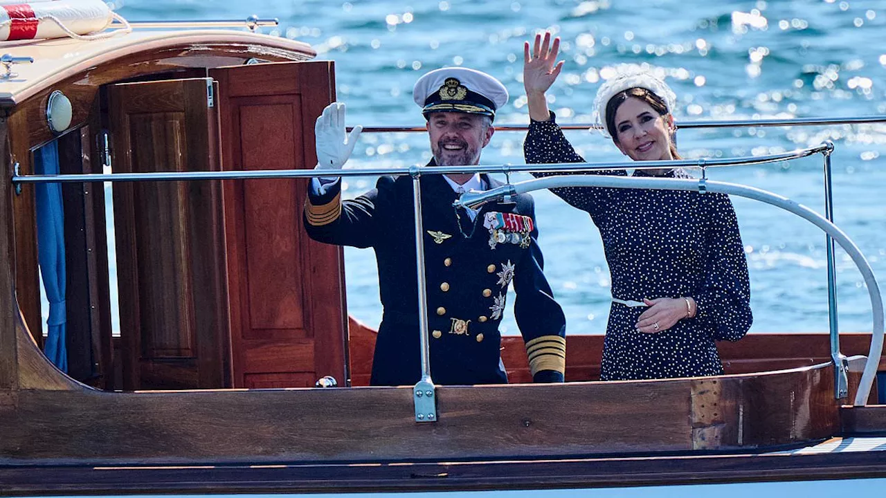 Queen Mary and King Frederik of Denmark beam as they wave goodbye and set off on their first summer...