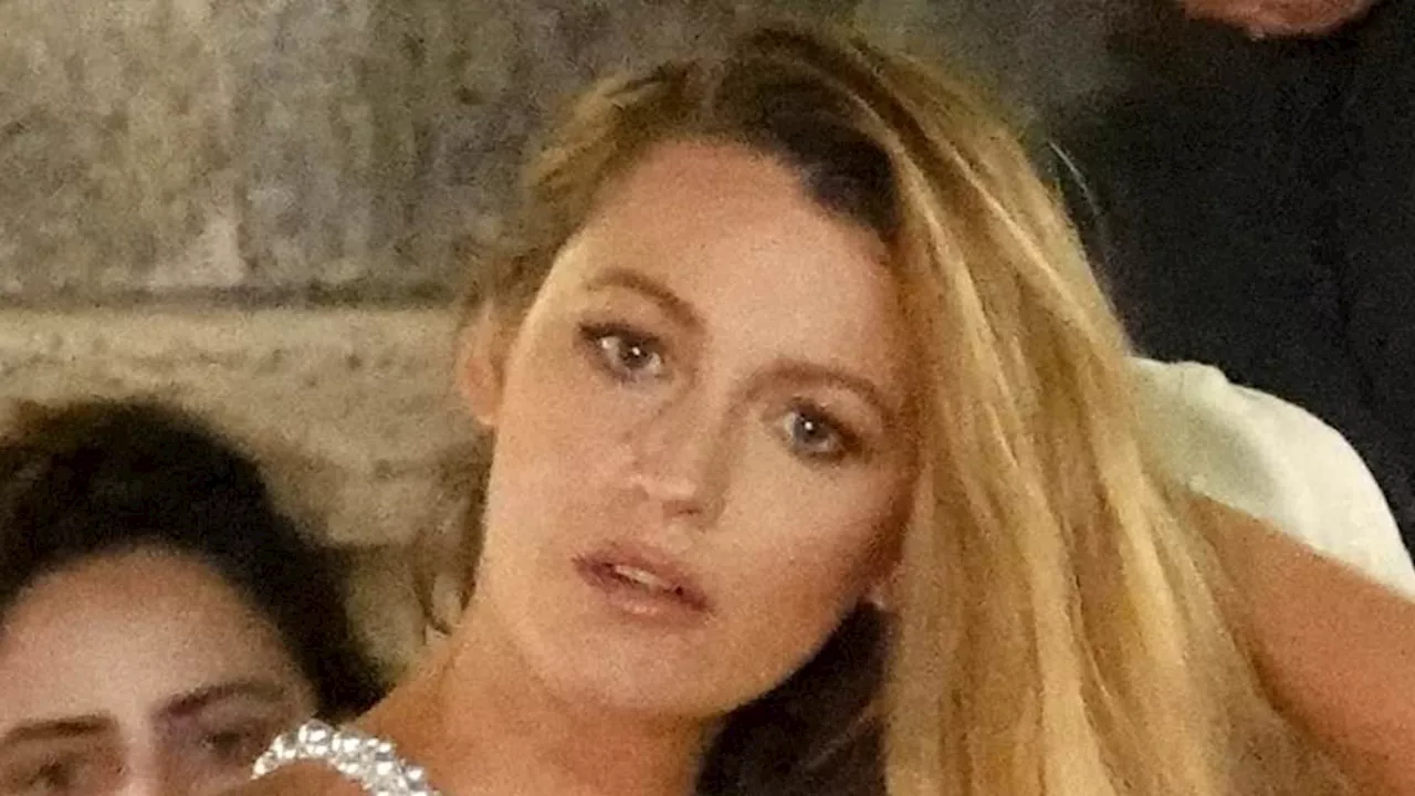 Blake Lively dazzles in a sheer pearl-embellished dress and satin bodysuit while on the set of the...