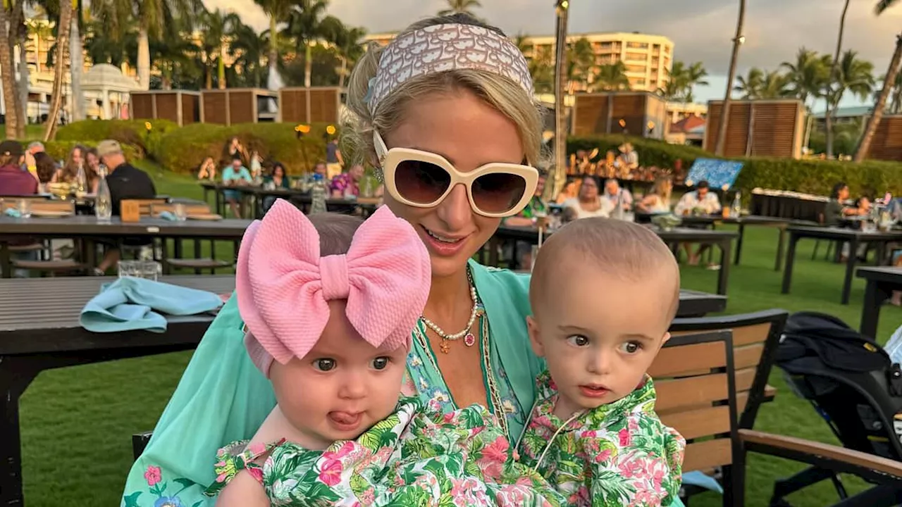 Paris Hilton cuddles with baby daughter London, six months, and son Phoenix, one, on the beach...