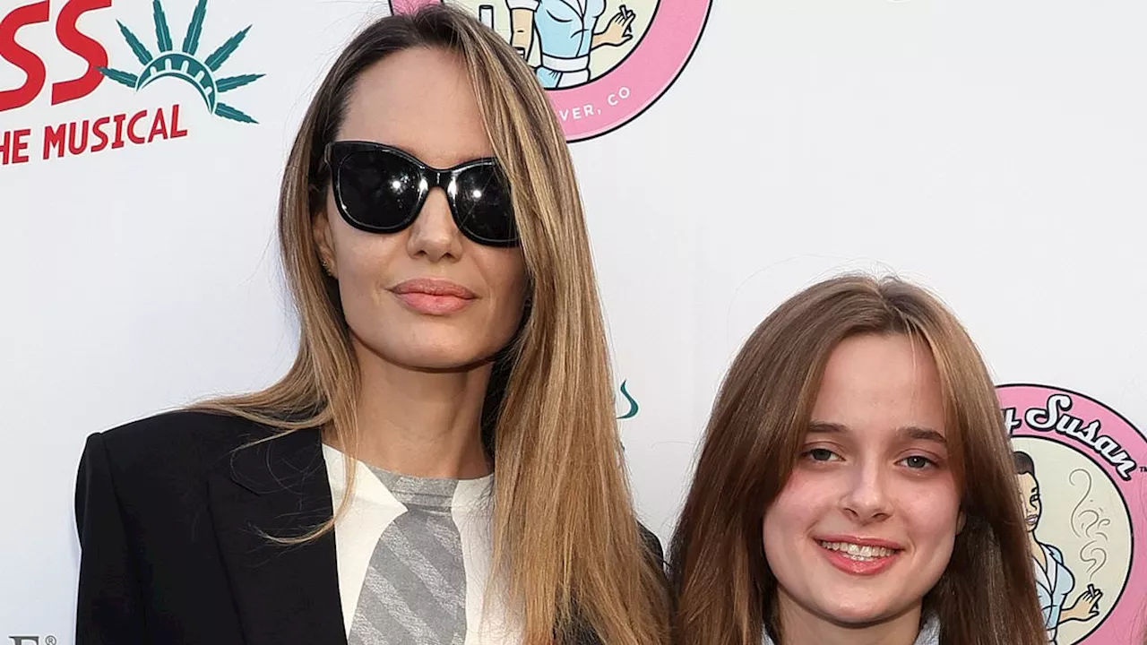 Angelina Jolie looks triumphant while posing with daughter Vivienne, 15, on red carpet after her...