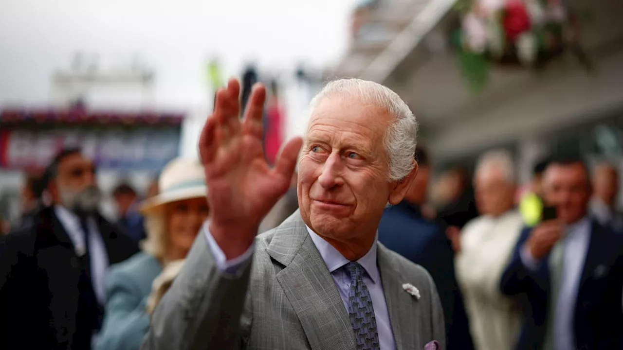 King Charles and Queen Camilla brave the rain for day at the races