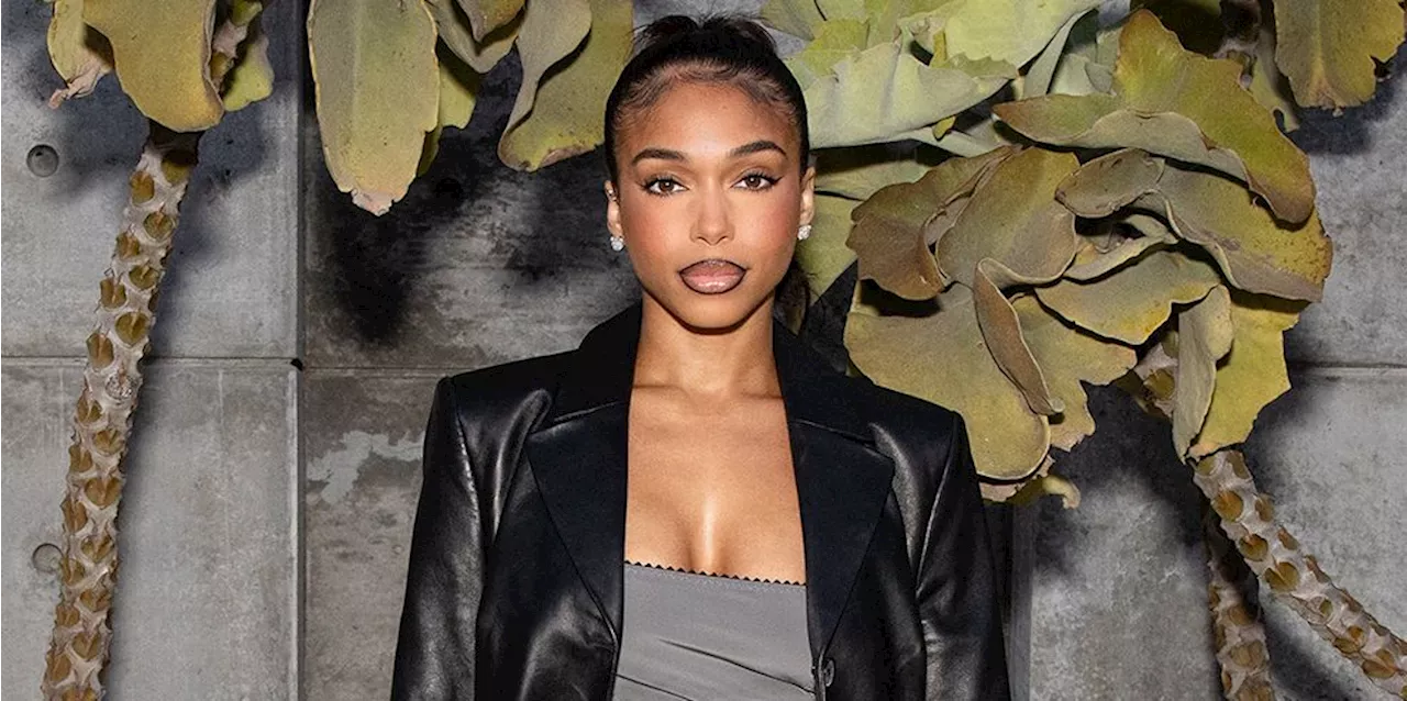 Lori Harvey Exudes ‘90s Chic In a Leather Trench Coat and Sparkly Heart Purse