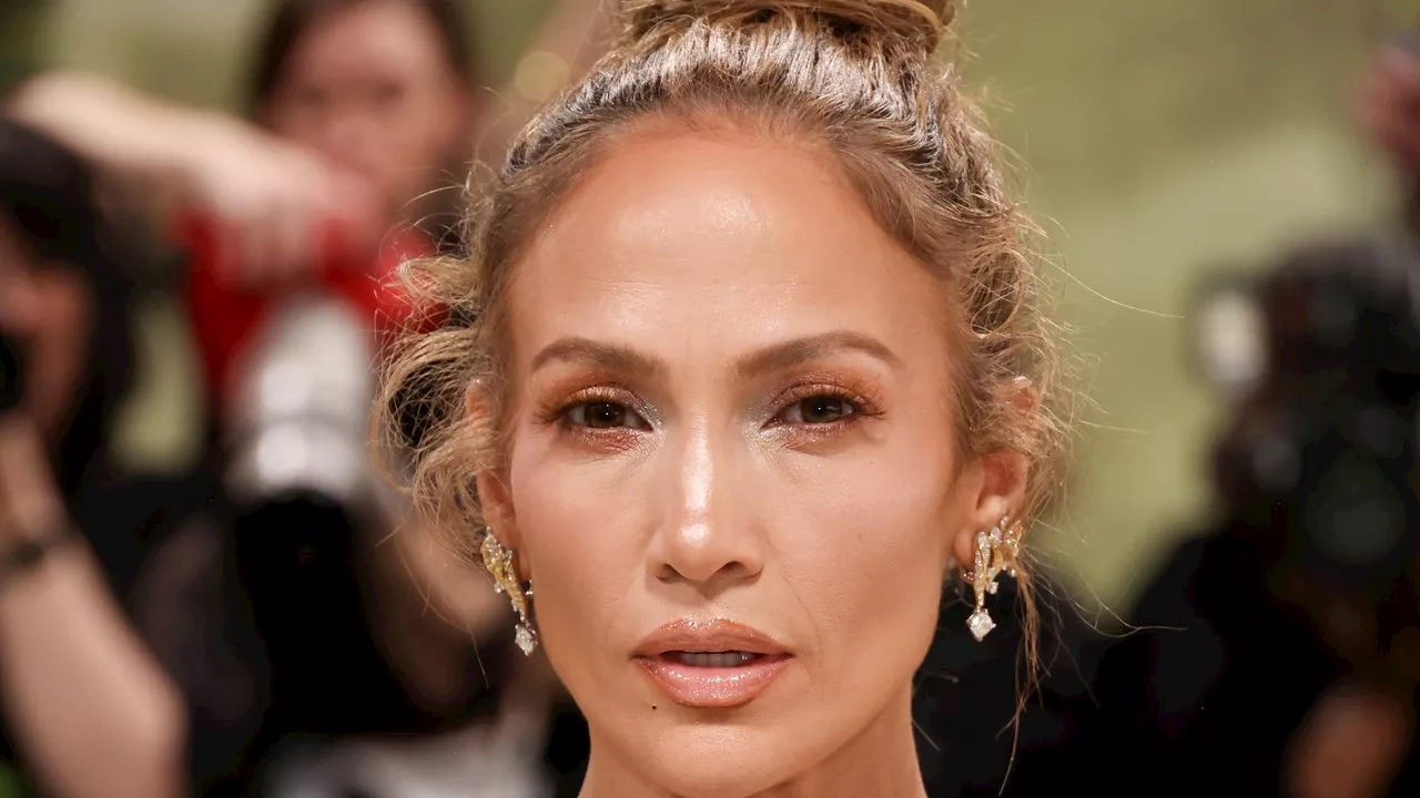 Jennifer Lopez Balances Her Near-See-Through Schiaparelli Dress With A Casual Top Knot At The 2024 Met Gala