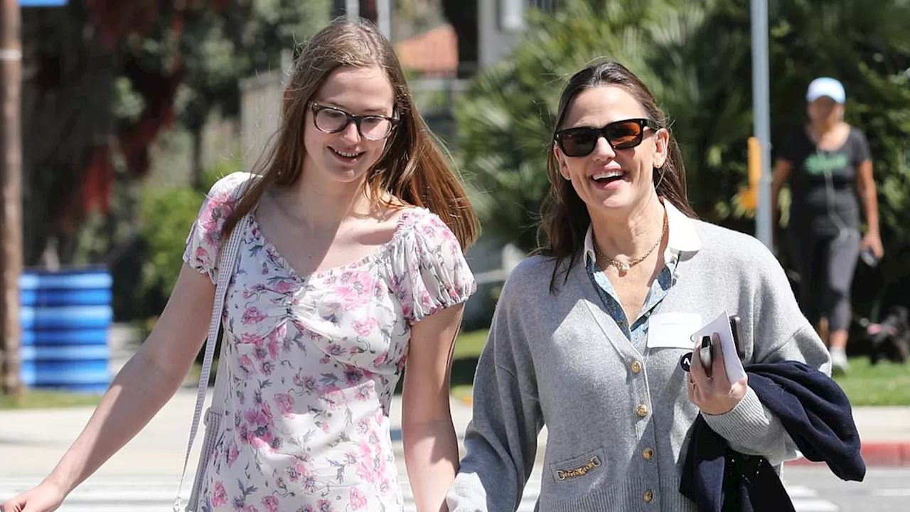 Jennifer Garner's look-alike daughter Violet, 18, towers over her mom, 52, as they sweetly hold...