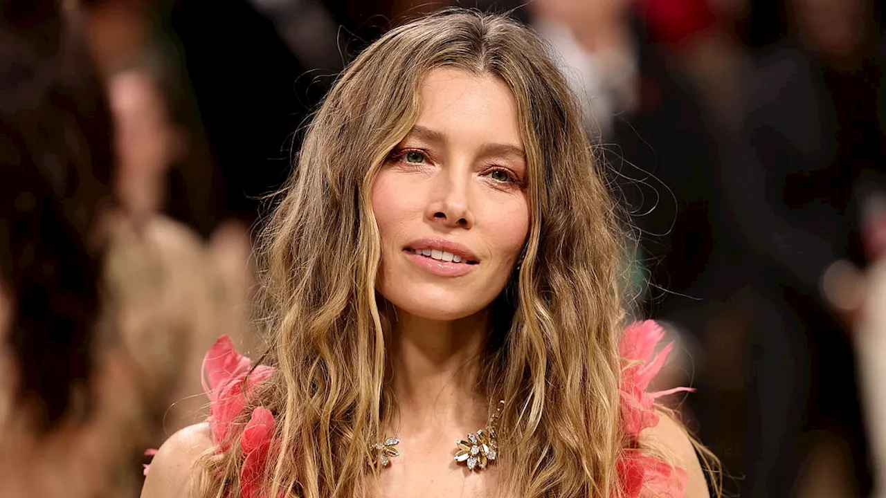 Jessica Biel goes braless beneath plunging pink feather-adorned gown as she arrives at the Met Gala...