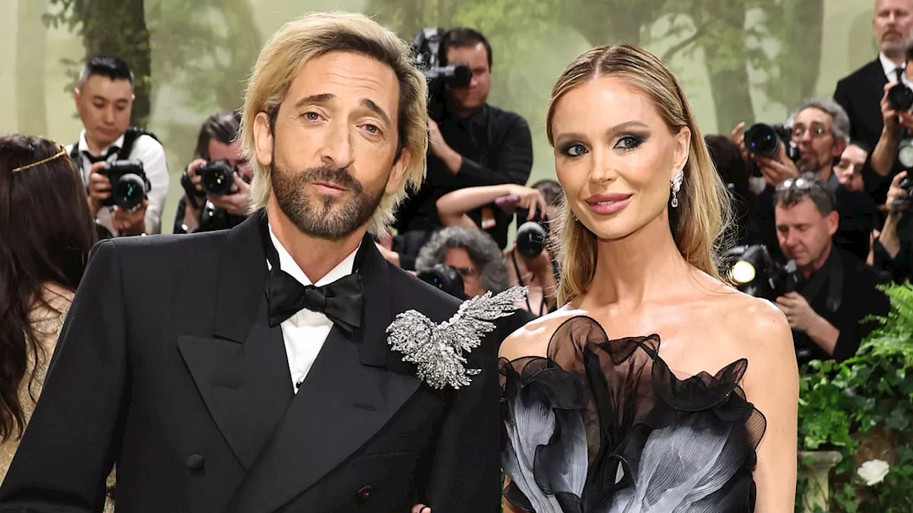 Adrien Brody debuts new blonde hair as he and glamorous girlfriend Georgina Chapman arrive to...