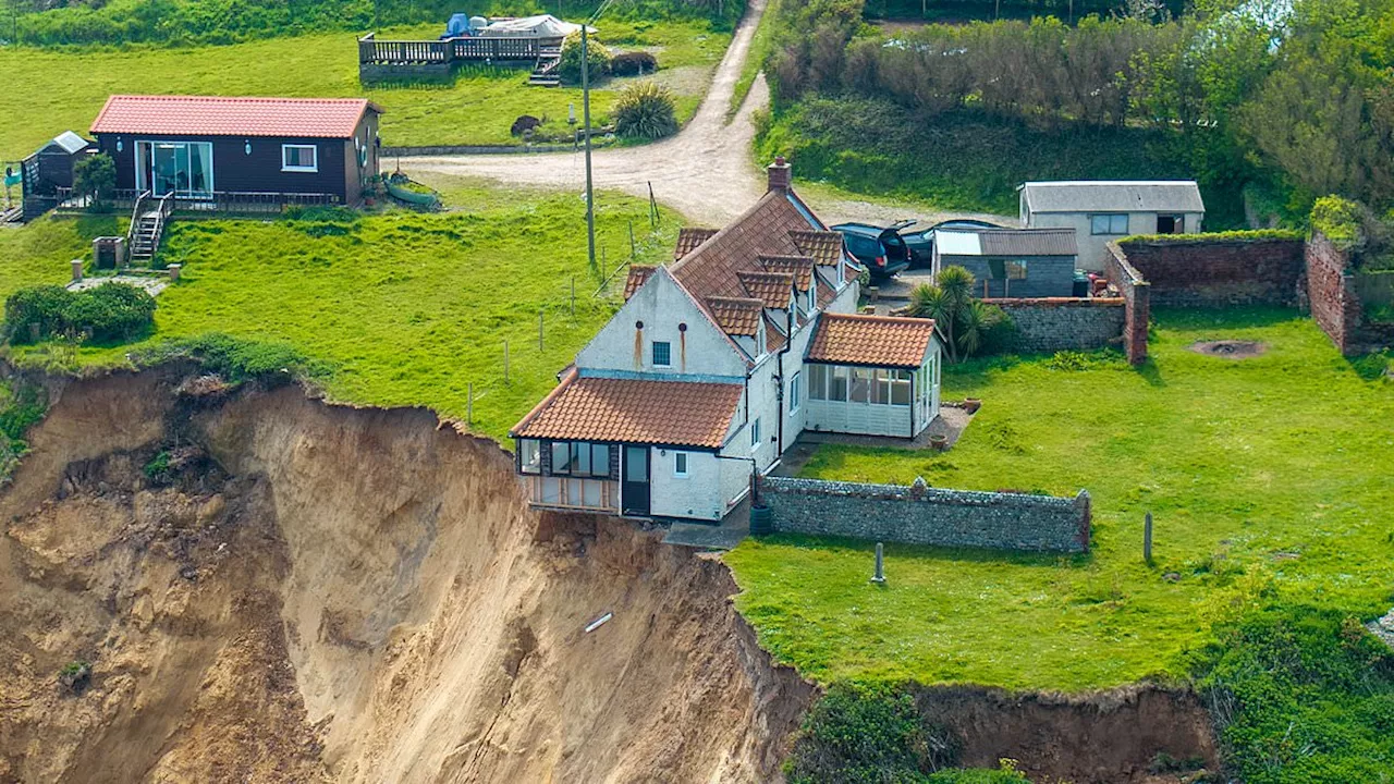 Drone footage shows Norfolk home close to collapsing as cliff crumbles