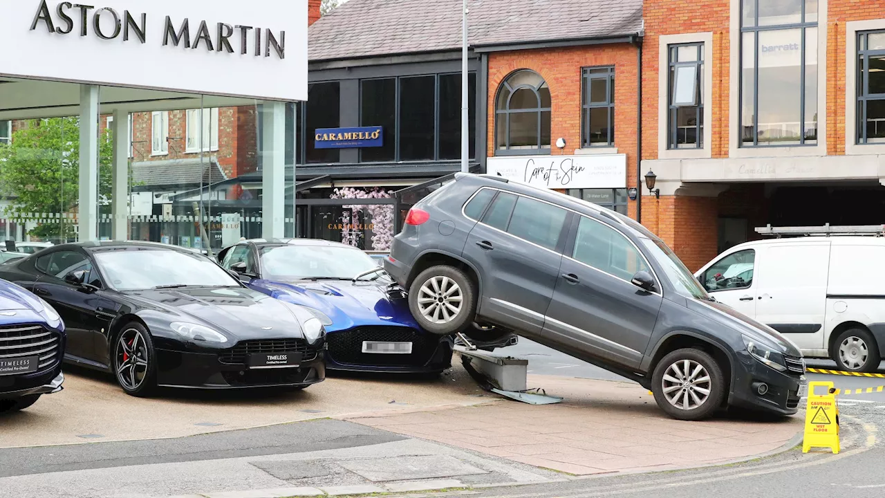 Red-faced driver facing huge insurance bill after reversing VW over a £210,000 Aston Martin supercar...