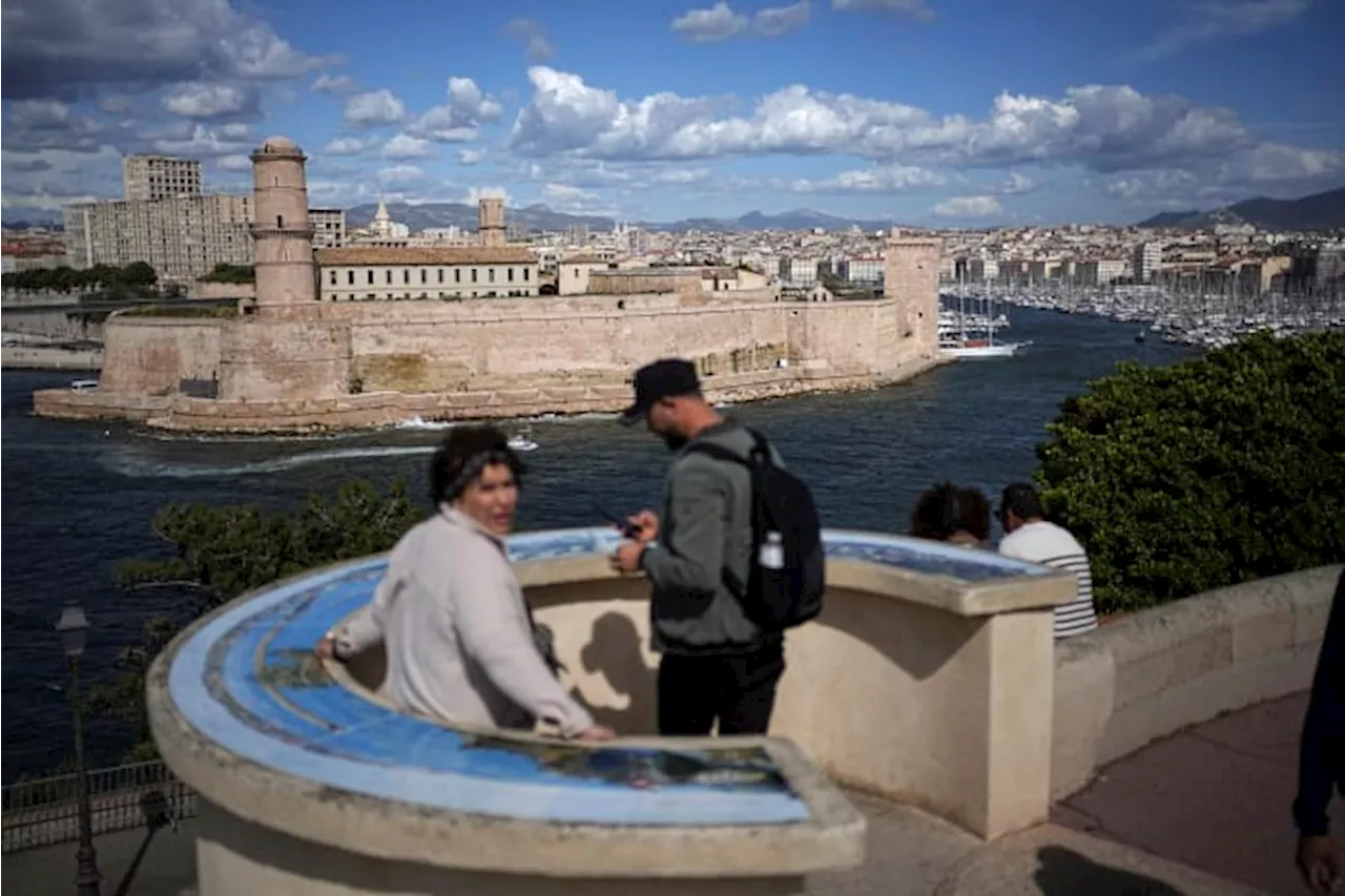 The Olympic torch is being welcomed in French port city of Marseille with fanfare and high security