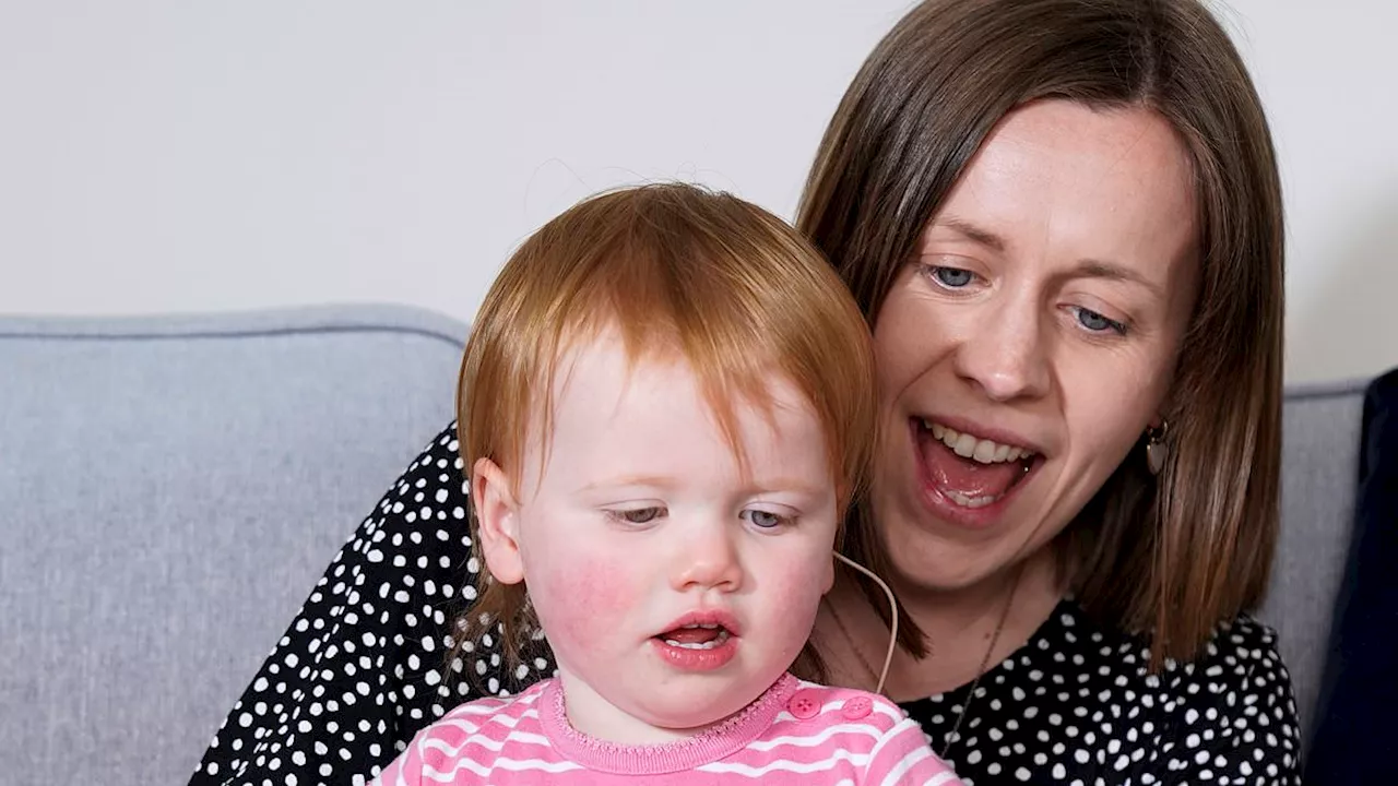 Joy as 18-month-old Opal is able to hear (and dance with her sister) for the first time after being...