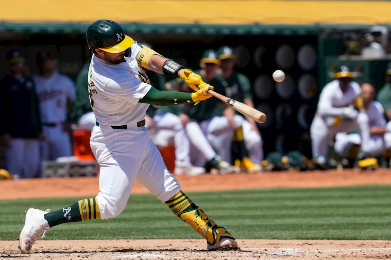 Athletics muscle up to beat Rangers in first game of doubleheader