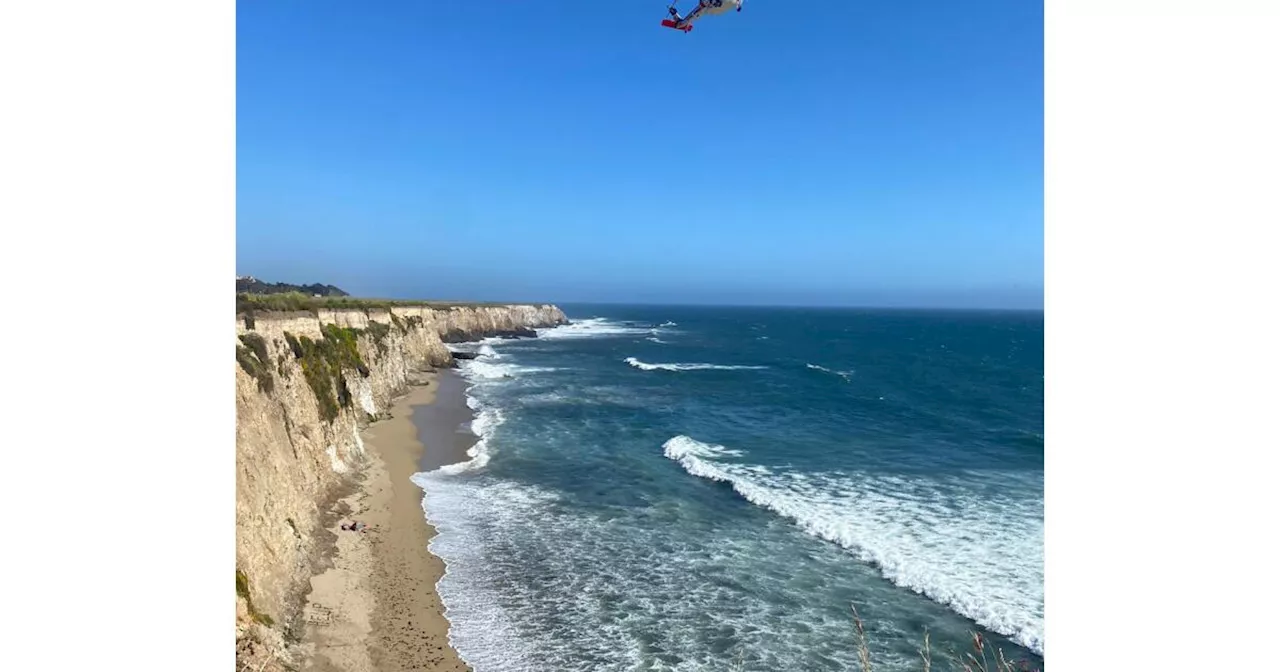 Stranded on a remote California beach, this windsurfer used rocks to spell 'HELP'