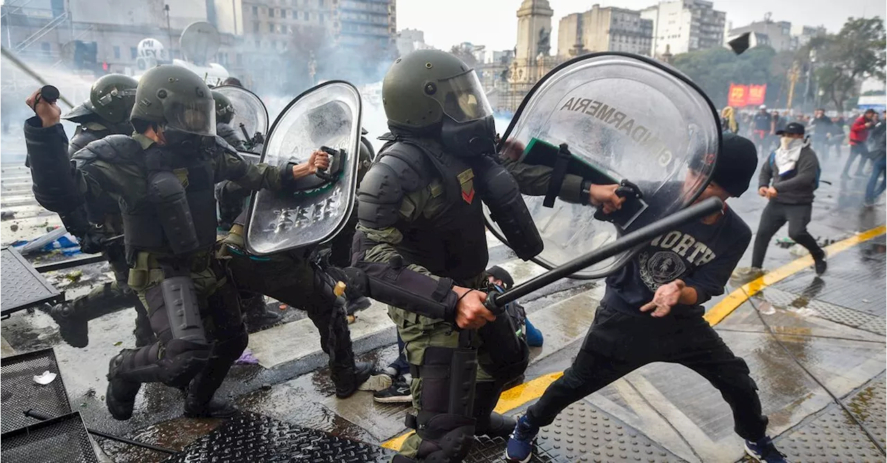 Tear gas, car fires and bloody clashes as Argentinians revolt against austerity