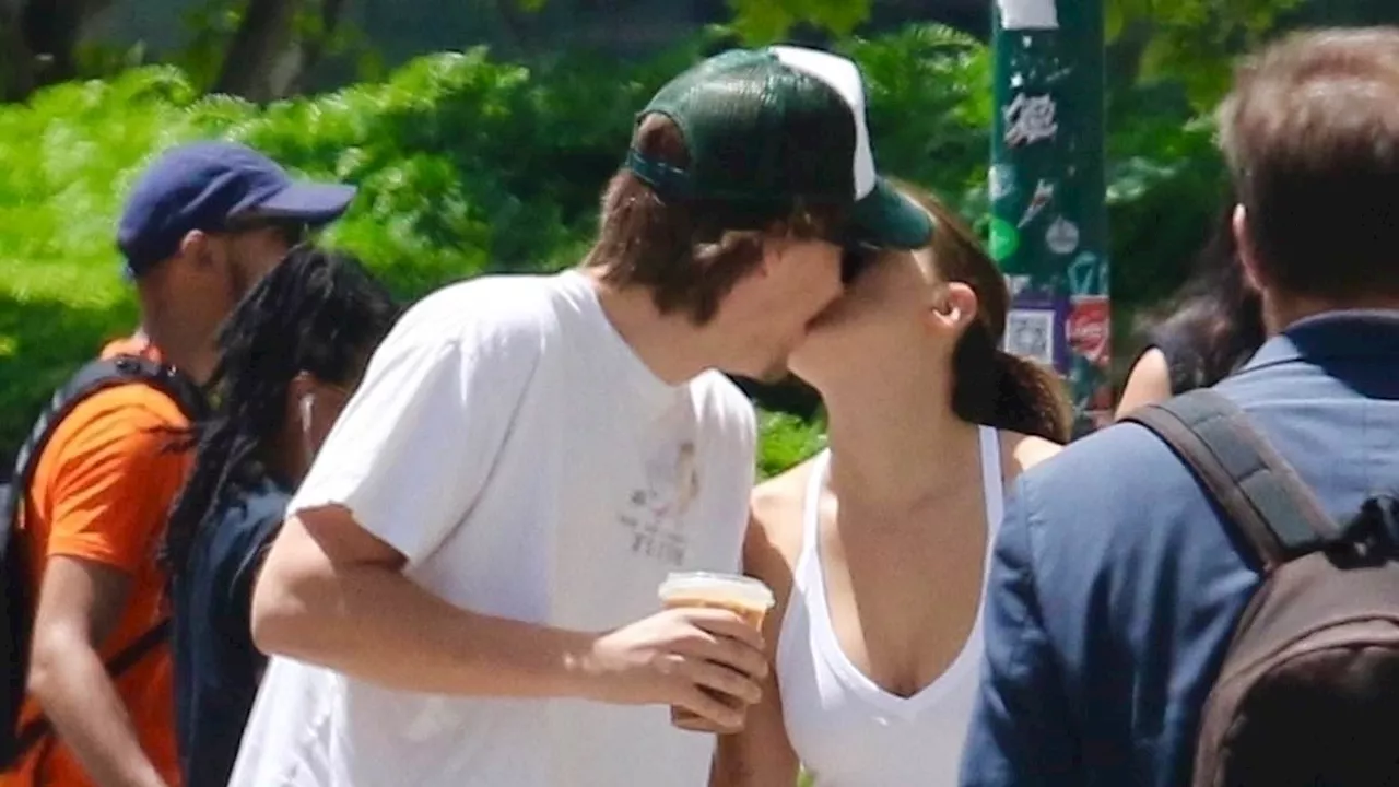 Millie Bobby Brown, 20, and her husband Jake Bongiovi, 22, kiss on a busy sidewalk in NYC... two...