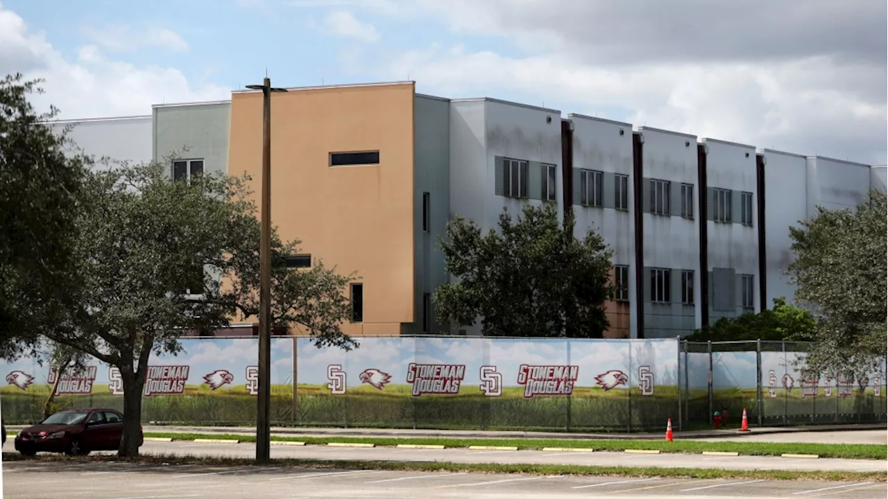 'A symbol of failure': Demolition of Parkland high school massacre site begins as families of the victims look on