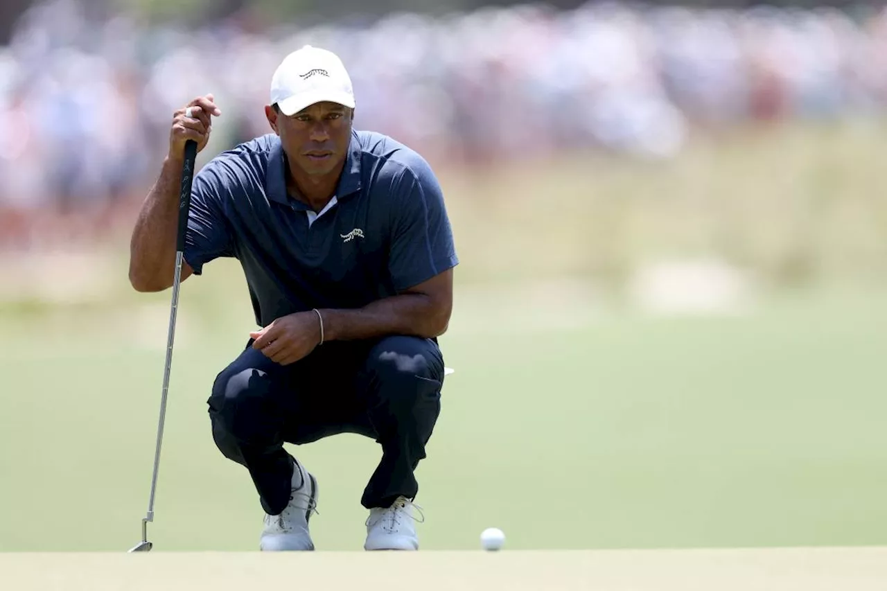 Three-time champ Woods misses cut