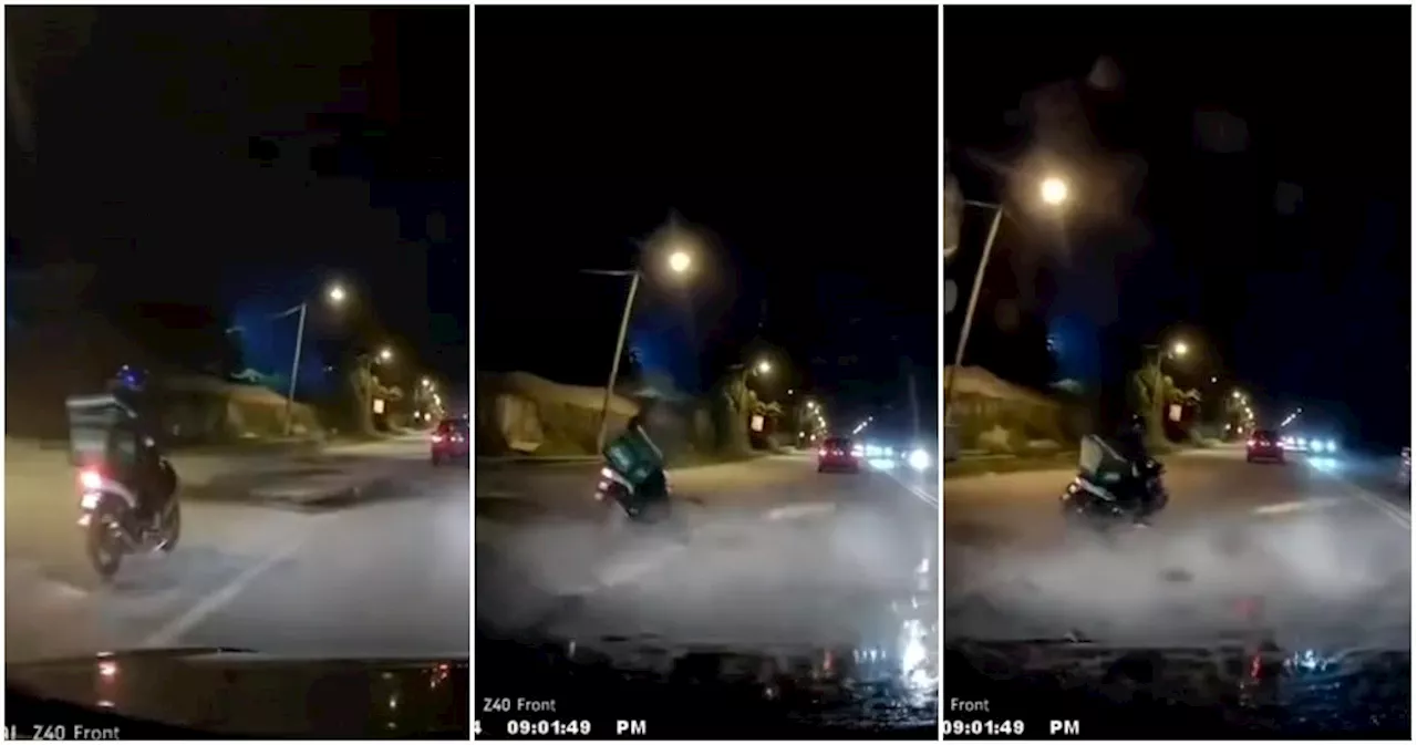 WATCH: Motorcyclist Loses Balance After Hitting Pothole, Netizens Question Authorities