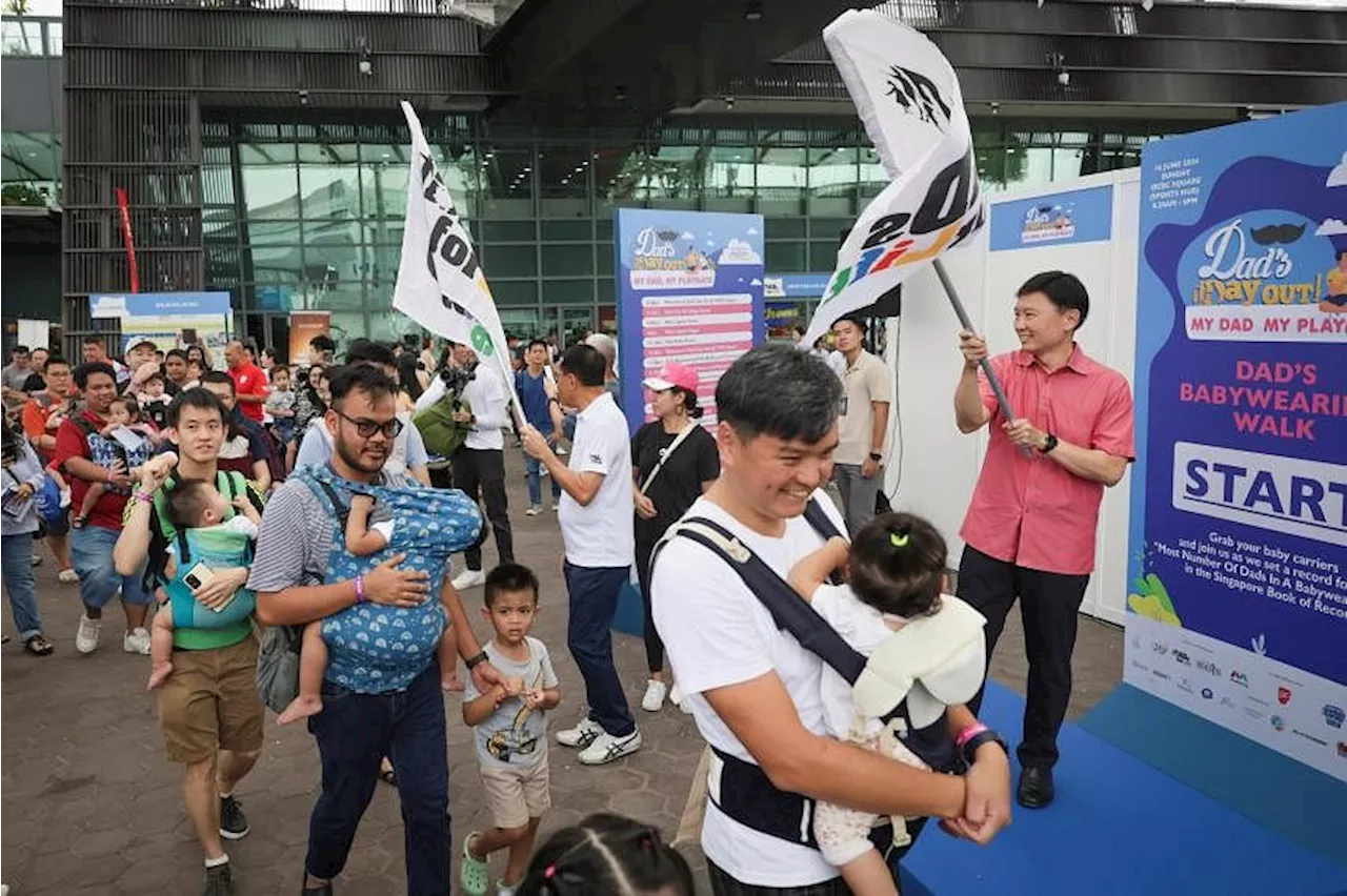 Baby-wearing dads celebrate Father’s Day with record-breaking walk in S’pore