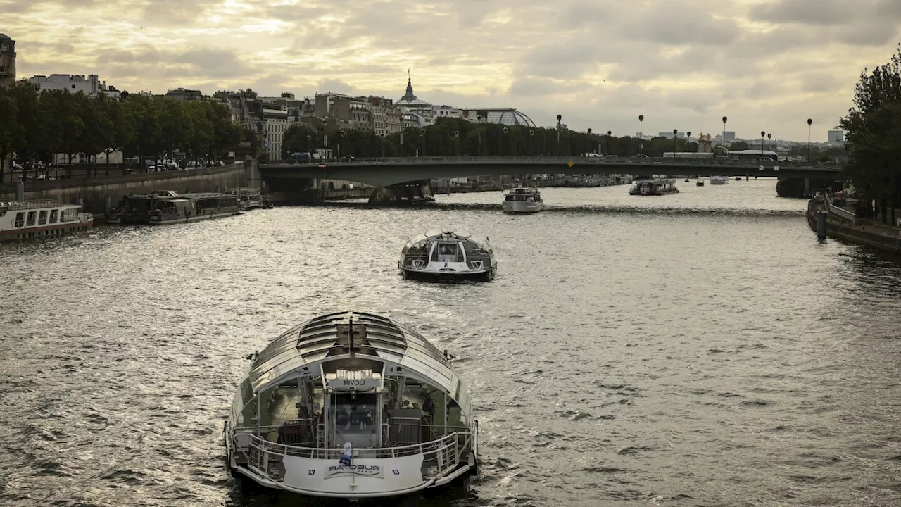 Dozens of boats cruise the Seine river in a rehearsal for the Paris Olympics’ opening ceremony