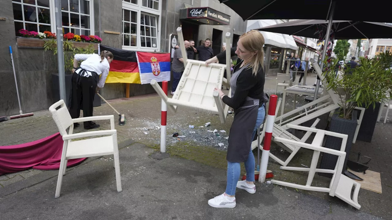 Police temporarily detain 8 after clash between Serbia and England fans before opening match