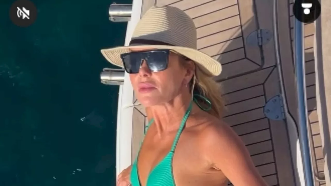 Amanda Holden, 53, leaves little to the imagination as she shows off her toned physique in a tiny...