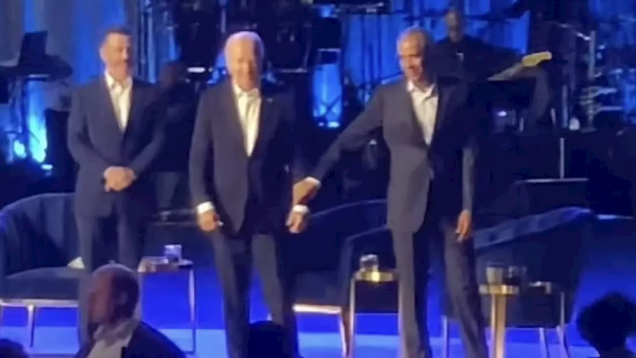 US President Joe Biden, 81, appears to freeze again before Barack Obama ushers him off stage