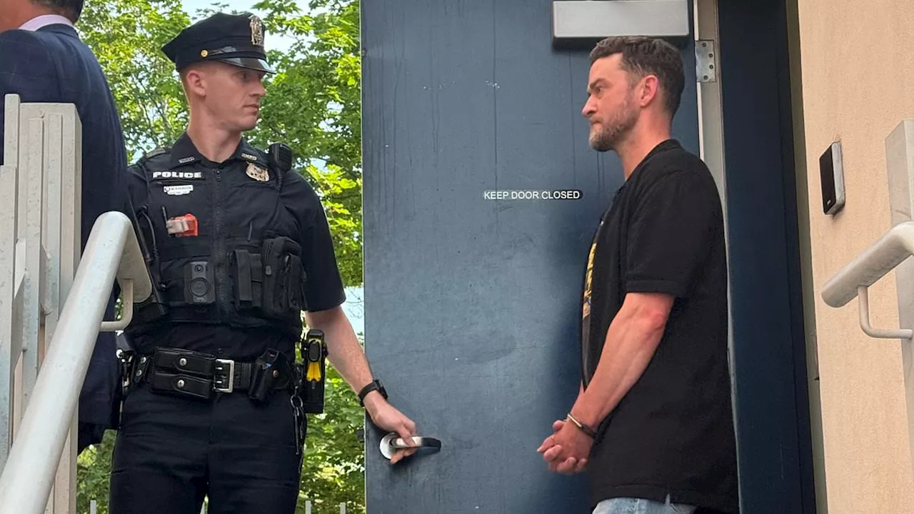 Justin Timberlake seen in handcuffs morning after his DWI arrest for blowing stop sign and refusing...