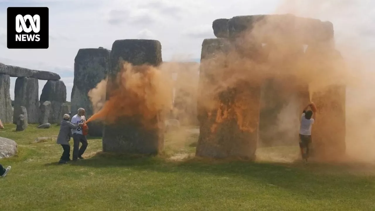 Climate protesters spray Stonehenge with orange powder paint before summer solstice celebrations